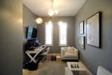 The front room retained the existing two narrow windows, given the historical designation of the original house.
