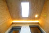 View looking up at the light fixtures and skylight.