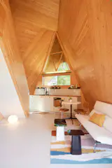 The ground floor is 440 square feet, complete with angled walls, a sitting area, and kitchen.