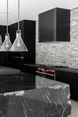 Kitchen, Stone Tile Backsplashe, and Range Photograph is a representation of possible finishes and not the actual home.  Photo 9 of 51 in Jewel Homes Azure model listed for $4.2M, designed by Peter Lik by Gavin Ernstone - Simply Vegas Real Estate