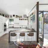 Kitchen, Recessed Lighting, Concrete Counter, Wall Oven, Concrete Floor, Undermount Sink, Cooktops, White Cabinet, Porcelain Tile Backsplashe, Refrigerator, and Quartzite Counter  Photo 8 of 10 in Earthquake-Resistant ADU by Studio PEEK | ANCONA