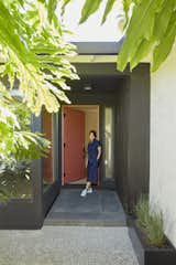 Natural light spills onto the threshold, inviting exploration. An architectural embrace awaits those who step inside.