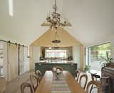 Kitchen, Engineered Quartz Counter, Ceiling Lighting, Drop In Sink, Light Hardwood Floor, and Pendant Lighting Combining contemporary and rustic in the Kitchen Dining Space  Photo 1 of 5 in Camhanaich by Fiddes Architects