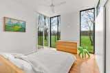 Bedroom, Dresser, Ceiling Lighting, Bed, and Light Hardwood Floor  Photo 7 of 19 in The Pinstripe House by Margaret Mikkelsen