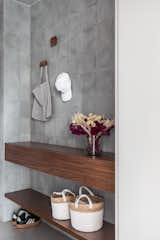 Hall | The main highlight of the apartment's materiality is certainly the gray hydraulic tile coating on the access corridor walls, an old wish of the couple.