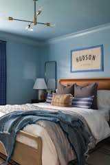 Bedroom, Ceiling Lighting, Night Stands, Shelves, Chair, Bed, Light Hardwood Floor, and Dresser Blue Skate Themed Boys Room  Photo 2 of 7 in Lake Life Project by MEGAN GRIBBLE HOME