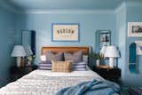 Bedroom, Light Hardwood Floor, Ceiling Lighting, Night Stands, Bed, Shelves, Bookcase, and Dresser Blue Skate Themed Boys Room  Photo 4 of 7 in Lake Life Project by MEGAN GRIBBLE HOME