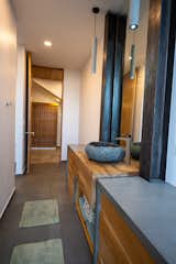 bathroom sink  cabinet... concrete, wood and stone construction. note the I beam insets