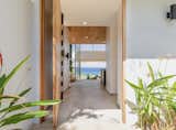 Staircase, Metal Railing, Wood Railing, and Wood Tread Front door entry view  Photo 12 of 17 in Endless Summer  Costa Rica by James Shaffer