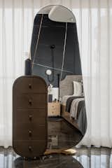 Daughters room was cladded with Saint Laurent and white Victorian tile ,wardrobe  was finished in veneer with jazz metallic handle , organic mirror  and dresser complemented the ceiling which we used to cover the beam right on the centre on the bed.