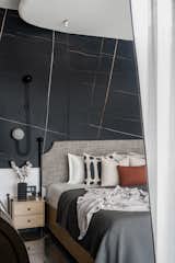 Daughters room was cladded with Saint Laurent and white Victorian tile ,wardrobe  was finished in veneer with jazz metallic handle , organic mirror  and dresser complemented the ceiling which we used to cover the beam right on the centre on the bed.