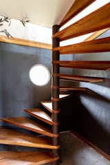 Spiral stair case made onsite from old rusty pipe and recycled timber