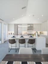 Kitchen, Cooktops, Engineered Quartz Counter, Range, Ceramic Tile Floor, Recessed Lighting, Subway Tile Backsplashe, Pendant Lighting, White Cabinet, Range Hood, Ceiling Lighting, Wood Cabinet, Undermount Sink, and Wall Lighting Kitchen main house  Photo 6 of 17 in 99 Ranch by Yu2e