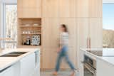 Ceramic Tile Floor, Engineered Quartz Counter, Ceiling Lighting, Wall Oven, Wood Cabinet, Cooktops, Refrigerator, Microwave, Track Lighting, Undermount Sink, and Dishwasher  Photo 8 of 20 in Forest House by Métamaison