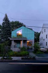 The gable-roofed home features sustainable Accoya wood siding and Tecu patinated copper by KME, experimental materials that Ricks had proposed for MASS Design Group competition entries but put in use for the first time here. His colleague, Sierra Bainbridge, designed the landscape.