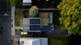 A series of solar panels and green roofs by Recover Green Roofs contribute to the energy efficiency of the house, which produces more electrical power than it consumes. MASS Design Group senior principal and cofounding member Sierra Bainbridge designed the home's landscape.