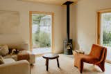 A Danish Morso wood stove is a focal point of the living room, where the family's Miniature Bull Terrier Hank naps on the sofa.