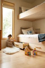 The three-bedroom home features a built-in bunk room. Large inset windows throughout allow an indoor-outdoor feel despite the single-story home's modest footprint, just over 1,000 square feet.