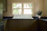 A vintage apron front sink now anchors the kitchen, with new cabinetry, drawer pulls by Linnea, and honed granite countertops.