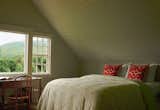 After: The light-filled primary bedroom features a bed, side tables, desk, shelf, console, and bookcase by designer Abigail Turin of Kallos Turin.