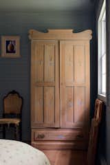 After: A Swedish-style wardrobe and antique furnishings add historic charm to the bedroom on the ground floor.