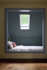 After: A bed for two occupies a new skylit nook on the second floor, further highlighted by its blue paint.