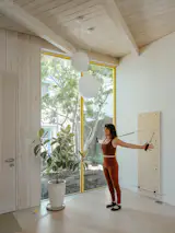 Locally sourced engineered flooring in the light-filled Pilates studio was easier on the budget and the body.