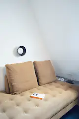 A table lamp by Angelo Mangiarotti and wall light by Egoluce provide an evening glow around the custom Bensen daybed.