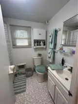 Before: The small bathroom had a dated designer and lacked a useful vanity.