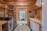 Open doorways create sightlines through every room to the surrounding woods.