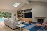 Lime plaster covers the original fireplace and television wall, now with its integrated cabinetry.