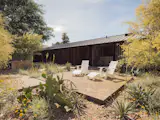 The new xeriscaped front garden, designed by local landscape studio Colwell Shelor, creates a desert habitat for local fauna and an inviting space for the homeowners to relax in Adirondack chairs by Loll Designs. 