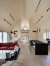 Architect Airaxin designed the home's accent lighting with Finnish company Spigot but the ceiling track lighting is from SuperLED. The living room seating area includes a Nakki sofa by Woud Design and a Barcelona chair by Ludwig Mies van der Rohe.