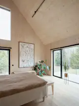 The main bedroom has a bed by Matri and custom wood benches.