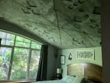Bedroom with detailed concrete ceiling 