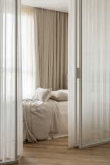 
The glass partition separates the communal space from the private sleeping area — the bedroom. The partition is adorned with sheer tulle, adding lightness and ambiance. I really wanted to convey a sense of being on vacation in the space, evoking feelings of ease, freshness, and carefreeness. The partition was custom-made. 