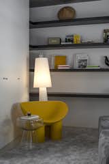 Having a cool spot on the living area for light computer work was one of the family requests, so we created a wall to wall shelf composition that could suit that need with
a laid back accent and colorful piece, Rolly Poly armchair by DRIADE.