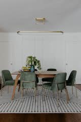 Dining Room, Dark Hardwood Floor, Table, Rug Floor, Pendant Lighting, Chair, Storage, and Ceiling Lighting Dining Room  Photo 6 of 6 in The Mehta Residence by Milena Bica-Shibata