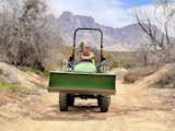 Heather Jo Leuthold working the John Deere with the Santa Catalina Range towering behind.