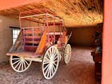 A covered wagon sits under a Saguaro Ribbed ceiling of the Carriage House.