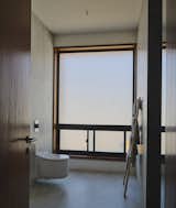 Bath 03 - Window: Tostem Japan Alumunium Autumn Brown Window Frame; Lights: Flos Shadow Dot; Fixtures: Grohe Wall-Hung Sensia Arena Shower Toilet; Materials: Art Parker Matt White Tile, Mahogany Wood