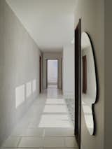 Circulation - Lights: Flos Shadow Dot; Materials: Textured Paint, Portland Limestone with Pillow Finish, Oak Laminate, Belgian Glass Mirror, Mahoghany Wood