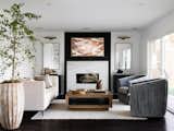 Living room - Quartzite fireplace surround, reeded matte black paneling 