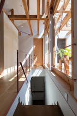 Hallway The light coming in through the handrail and skylight.  Photo 1 of 9 in Home for the family by Koki Sugawara