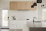 Minimal kitchen design with flush cooktop and hidden hood