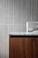 Bath Room, Porcelain Tile Floor, Freestanding Tub, Marble Counter, Wall Lighting, Vessel Sink, and Porcelain Tile Wall Bathroom sink detail  Photo 16 of 22 in The Black Silhouette Apartment by ORKO STUDIO
