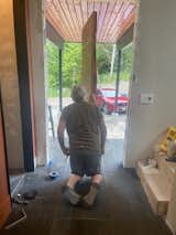 Installing the door in the pivot hinge.