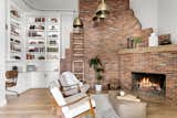 A cozy nook with dramatic brick fireplace extending to the ceiling.