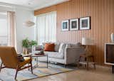 Transform your living room into a stylish and inviting space with the perfect combination of two shades on the walls. The wooden color exudes warmth and elegance, creating a cozy ambiance, while the white color adds a touch of sophistication. Paired with a comfortable sofa and tasteful decor, this setting promises a harmonious blend of comfort and aesthetics for your ultimate relaxation and enjoyment.​