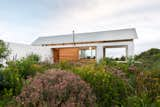 Outdoor, Front Yard, Gardens, Shrubs, Flowers, and Wood Patio, Porch, Deck Clusters of perennials in a backyard garden.  Photo 4 of 21 in House Swanepoel by KLG Architects from 14 Backyard Landscape Designs That Need Minimal Maintenance